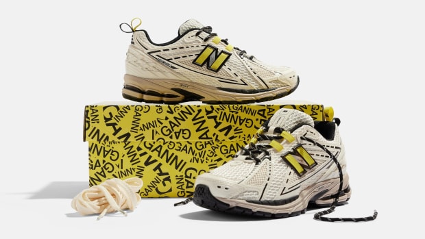 Side view of egret and black New Balance shoes.